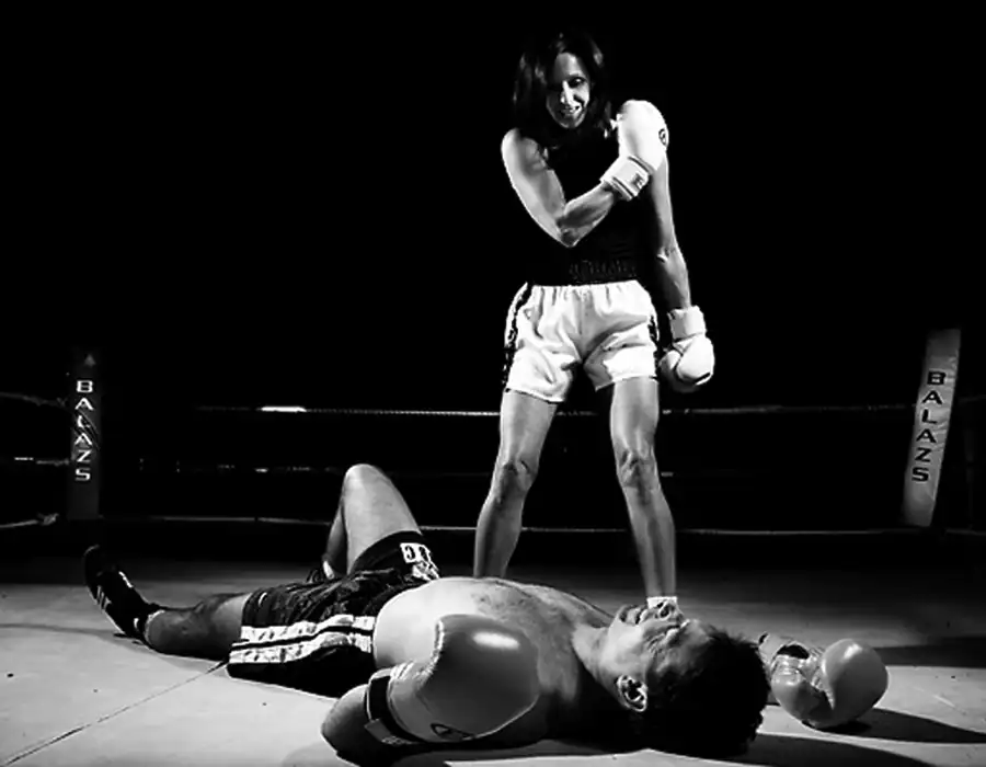 female fighter knocking out male fighter